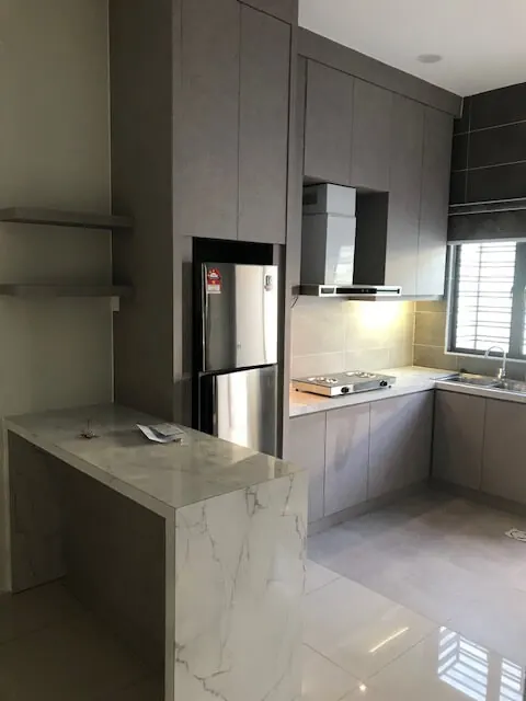 Kitchen we built with grey cabinets and a white marble-look quartz waterfall island beside the fridge