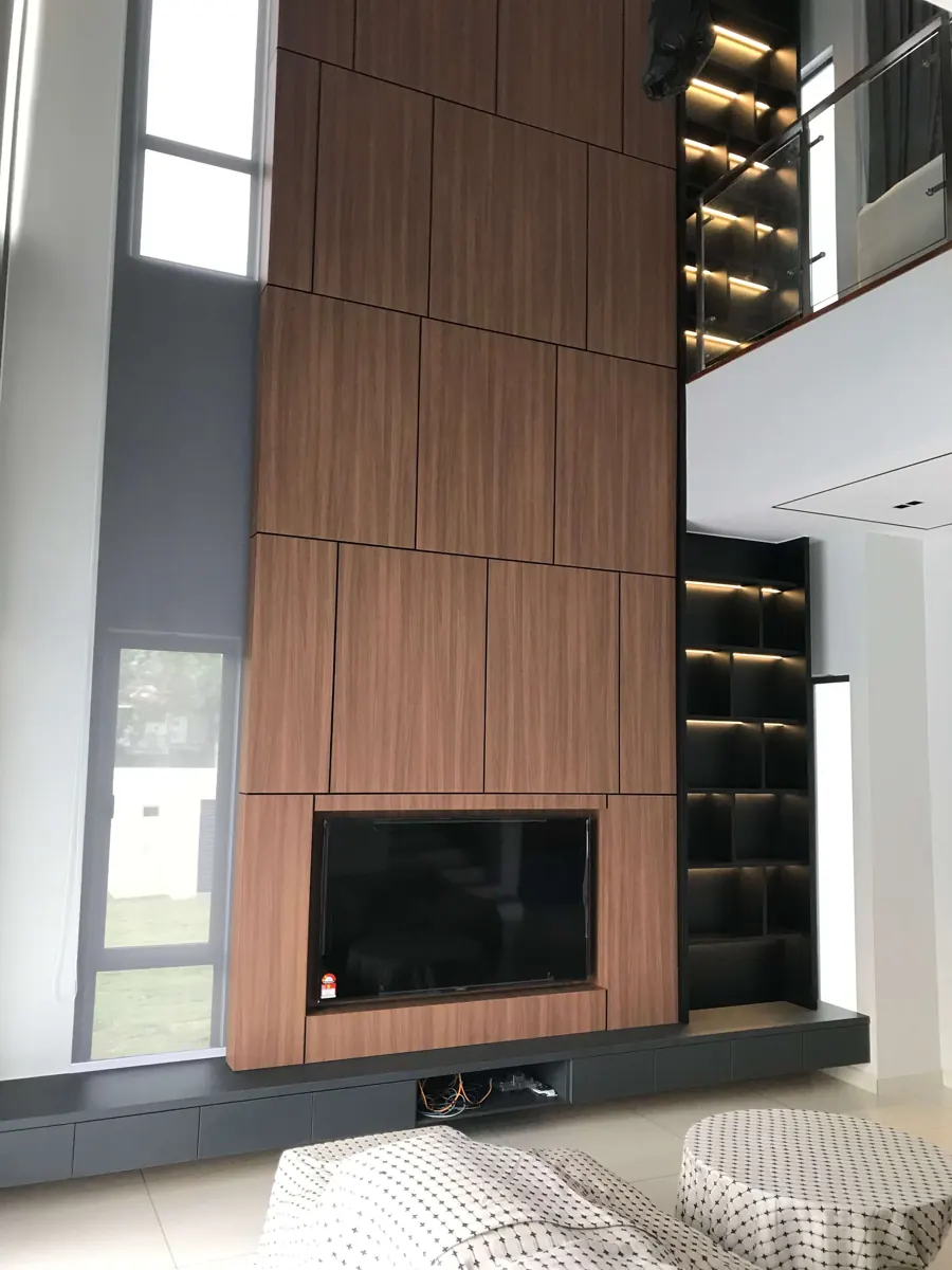 Tall living room feature wall in walnut wood-grain panels with a built-in TV and lit black display shelves