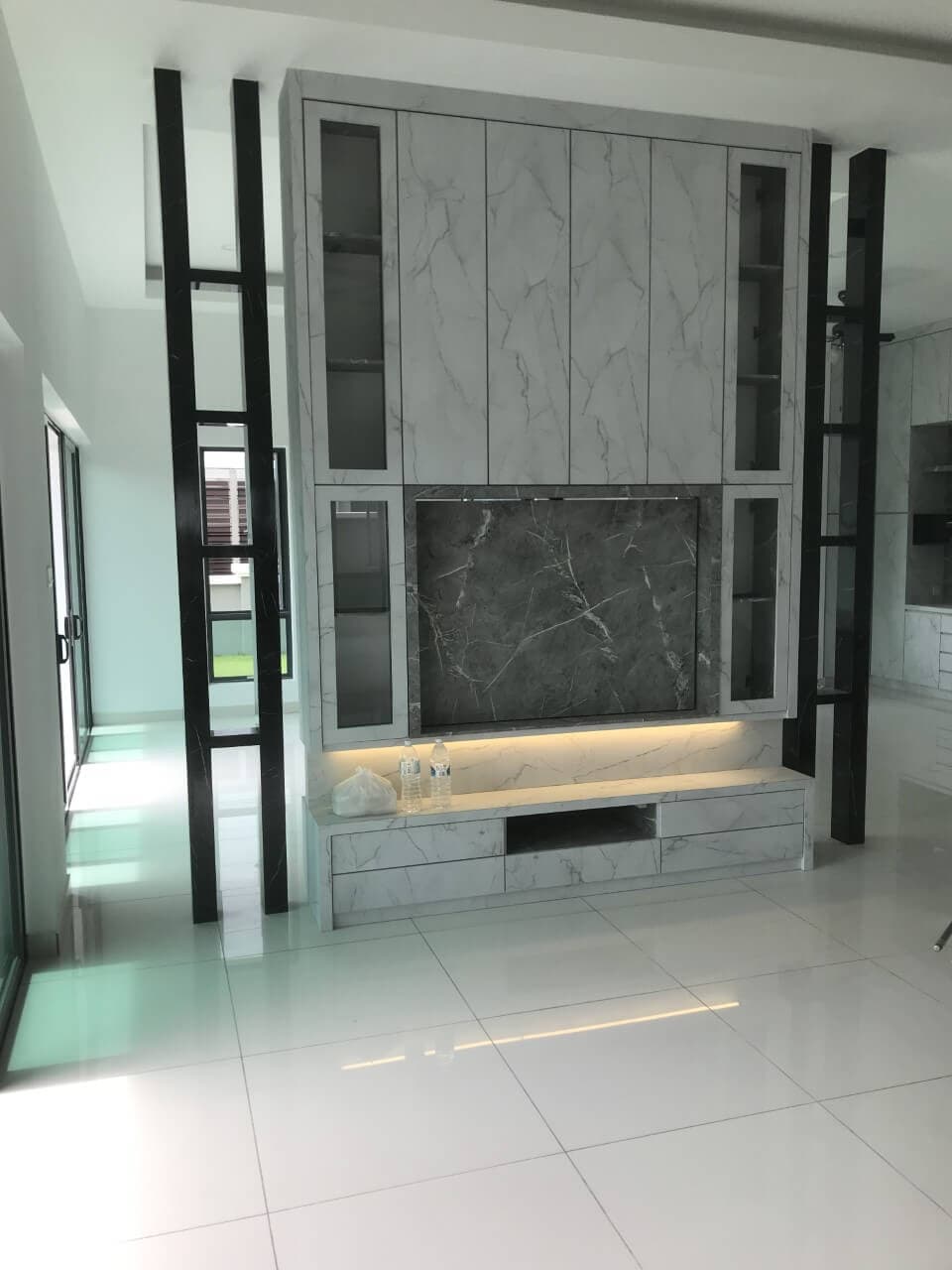 Marble TV wall with glass display cabinets and black screen columns, Taman Ozana Impian, Melaka