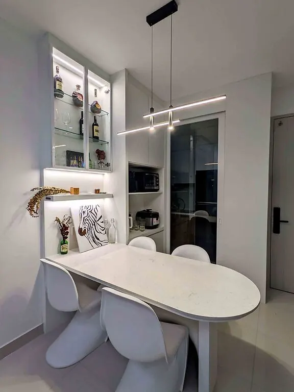 Dining nook with glass display cabinet, microwave and rice cooker shelf, and a glass sliding door to the kitchen