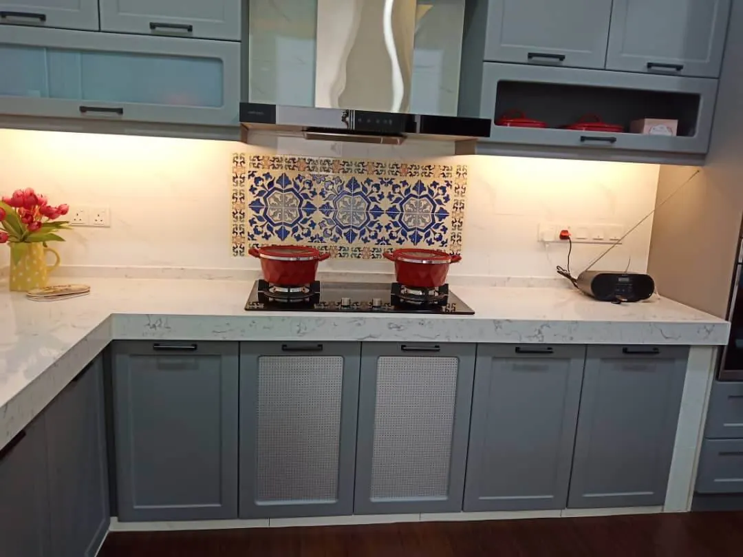 Kitchen we built with grey shaker cabinets, white quartz top, blue patterned tile splashback and a gas hob