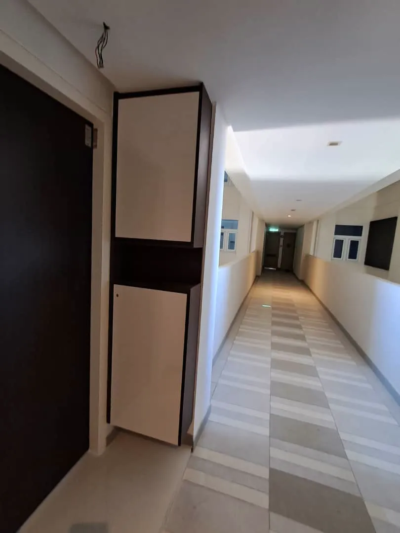 Kabinet kasut di sebelah pintu utama, pintu putih pudar dengan bingkai gelap, MET 1 Residences
